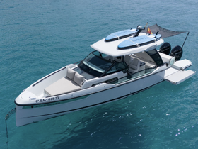 A stunning aerial view of a Saxdor 320 yacht anchored in clear turquoise waters, showcasing its sleek design and spacious deck, perfect for luxury outings.