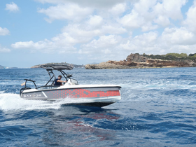 A speedboat navigates through the vibrant blue waters, showcasing an exhilarating day on the sea — perfect for adventure seekers.