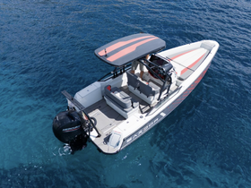 Aerial view of a sleek speedboat cruising through clear blue waters, showcasing its modern design and spacious seating — perfect for thrilling water adventures.