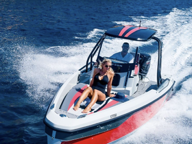 A couple enjoys a thrilling ride on a speedboat, showcasing the excitement of on-water adventures in the sun.