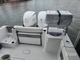 Interior view of a sport fishing boat showcasing seating and console features, ideal for comfortable outings on the water.