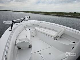 A clean and spacious interior view of a boat's helm and seating area, showcasing comfortable white upholstery ideal for relaxing on the water.