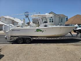A side view of a Sportsman boat named 'Just Jokin II' docked and ready for fishing adventures, showcasing its sleek design and fishing gear.