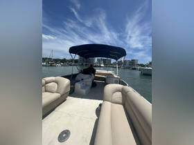 Inside view of a pontoon boat featuring comfortable seating and a helm, perfect for leisurely outings on the water.
