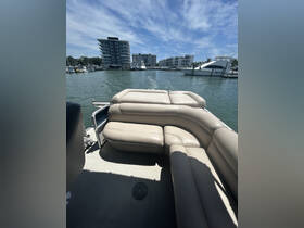Interior view of a comfortable seating area on a boat, showcasing a spacious cabin perfect for relaxing while enjoying the water.