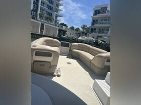 Interior view of a comfortable lounge area on a pontoon boat, featuring plush seating and a relaxing atmosphere, perfect for enjoying time on the water.