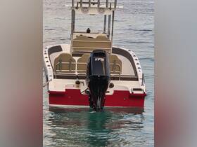 A striking view of a center console boat docked in calm waters, showcasing its sleek design and powerful motor — perfect for fishing or leisurely outings.