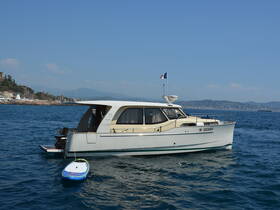 A beautiful yacht anchored in clear waters, showcasing its elegant design against a scenic coastal backdrop.
