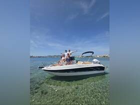 A lively group enjoys a sunny day on a boat, celebrating together in clear waters — perfect for fun outings and memorable experiences.