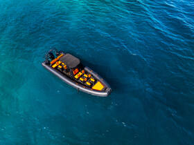 Aerial view of a sleek speedboat cruising through crystal-clear turquoise waters, perfect for adventurous outings and water sports.