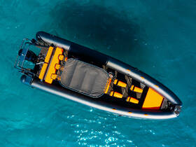 Aerial view of a sleek speedboat featuring vibrant orange seating against a backdrop of clear turquoise waters, perfect for thrilling adventures on the sea.