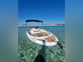 A sleek speedboat anchored in crystal-clear waters, showcasing its elegant design and inviting seating area — perfect for a day of relaxation on the water.