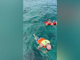 Two snorkelers enjoy the vibrant underwater world, showcasing the fun and adventure of snorkeling in crystal-clear waters.