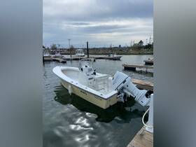 A pristine SeaCraft center console boat docked at the marina, showcasing its sleek design and ready for a day on the water.