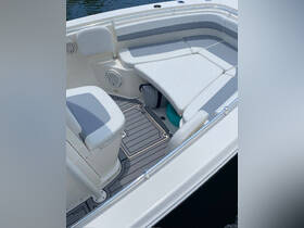A clean and spacious interior view of a boat's seating area, showcasing comfortable lounge space ideal for relaxation on the water.