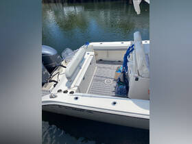 A well-equipped boat interior featuring seating and a helm area, perfect for a day out on the water.