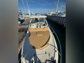 A view of a boat docked at the marina, showcasing its sleek design and comfortable seating area, perfect for day trips on the water.