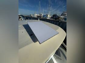 A close-up view of a boat's equipment on the deck, showcasing the details of the onboard amenities in a marina setting.