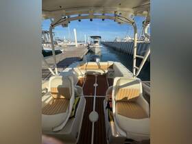 Interior view of a well-equipped boat showcasing comfortable seating and a clean helm area, perfect for a day on the water.