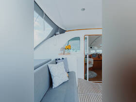 A beautifully designed interior of a boat featuring comfortable seating and decorative elements, perfect for relaxing while cruising on the water.