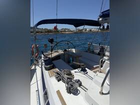 An interior view of a sailboat's helm and console area, showcasing the nautical equipment and spacious layout, perfect for sailing adventures.