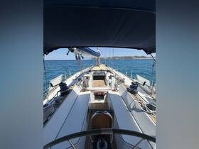 A detailed view of the helm area inside a sailboat, showcasing the seating and navigation equipment, perfect for sailing enthusiasts.