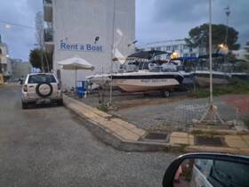 A view of a boat rental area featuring several boats parked at a dock, ideal for those looking to explore the waters.