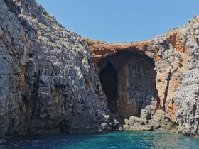 A stunning view of a rocky coastline featuring a natural cave, perfect for exploring the beauty of marine landscapes.