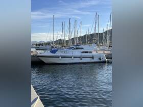 A sleek yacht docked in a marina, surrounded by masts of sailboats, showcasing a perfect setting for luxury boating experiences.