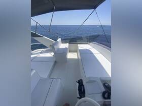 A clean and spacious interior view of a boat's helm and seating area, ideal for relaxing and enjoying the open water.