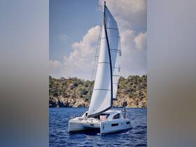 A sleek catamaran sails through clear waters, showcasing its elegant design and perfect for adventurous outings on the sea.