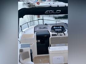 A detailed view of the helm area inside a modern boat, showcasing the console and seating — perfect for navigating the waters in style.