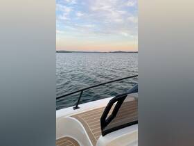 A serene view from the side of a boat, showcasing calm waters and a pastel sky — perfect for peaceful outings on the water.