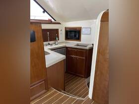A well-equipped boat kitchen featuring modern appliances and elegant wood finishes, perfect for preparing meals while at sea.