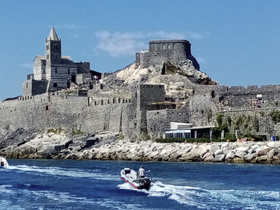 A picturesque view of a historic coastal fortress, showcasing its impressive stone architecture against a clear blue sky — a perfect backdrop for boating adventures.