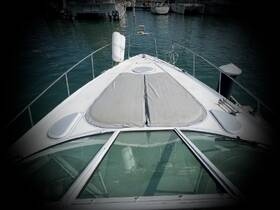 A clear view of the front deck of a yacht docked at the marina, showcasing its sleek design and inviting space for relaxation.