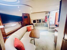 A cozy interior view of a boat's cabin featuring comfortable seating and a dining area, perfect for relaxing during your nautical adventures.