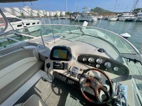 A detailed view of the helm and console area inside a boat, showcasing the modern navigation equipment and comfortable seating — ideal for a day on the water.
