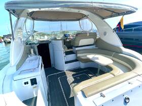 A spacious interior view of a boat's cabin featuring comfortable seating and a helm area, perfect for relaxing or navigating during a day on the water.