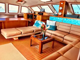 A beautifully designed interior of a yacht featuring comfortable seating and a stylish helm area, perfect for relaxing while cruising the open waters.