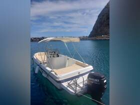 A sleek speedboat docked in calm waters, showcasing its clean lines and inviting seating area, perfect for a day out on the water.