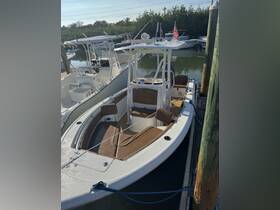 Interior view of a well-equipped boat featuring comfortable seating and a helm, perfect for a day on the water.