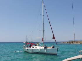 A couple enjoys swimming in the turquoise waters next to a sailboat, creating a perfect backdrop for a fun day on the water.