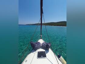 A serene view from the bow of a sailboat, showcasing comfortable bean bags and crystal-clear waters, perfect for a relaxing day on the sea.