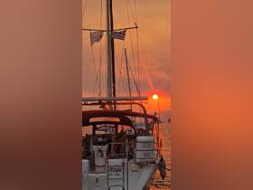 A stunning sunset view of the sailboat 'Argo' docked, with vibrant colors illuminating the sky — perfect for capturing the serene beauty of a day on the water.