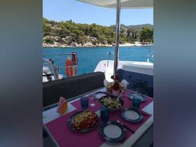 A beautifully arranged dining setup on a boat featuring fresh salads and drinks, perfect for enjoying meals while cruising on the water.