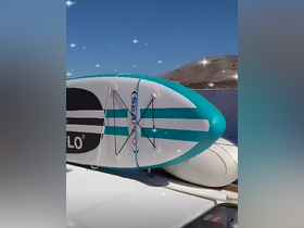 A paddleboard secured on the deck of a boat, ready for fun on the water — perfect for exploring serene coastlines or enjoying a day of adventure.