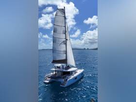 A stunning catamaran sails through crystal-clear waters, showcasing a perfect day on the water with guests enjoying the experience.