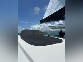 A comfortable lounge area on a catamaran, featuring plush seating, perfect for relaxing while enjoying the scenic views at sea.