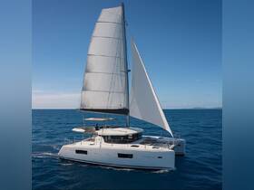 A stunning catamaran sails gracefully through clear blue waters, showcasing its sleek design and perfect for adventurous sailing trips.